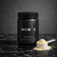 HIS 1 tub with a scoop of pineapple powder on black marble